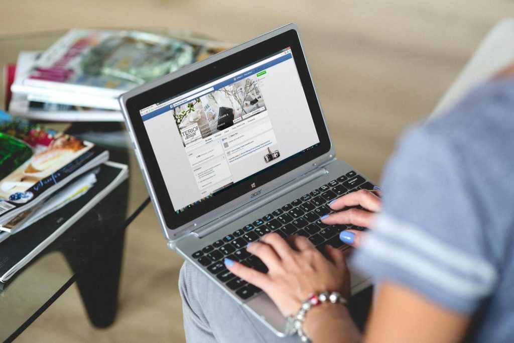 Women typing on the notebook.
